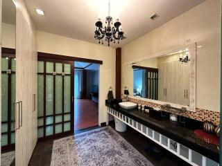 Modern bathroom with vanity and chandelier