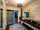 Modern bathroom with vanity and chandelier