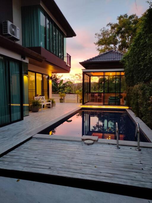 Modern house with pool at sunset