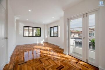 Bright and spacious living room with hardwood floors and French doors