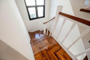 Staircase with wooden steps and window