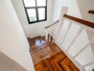 Staircase with wooden steps and window