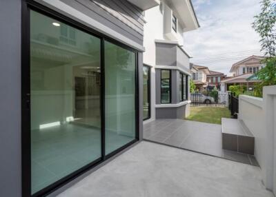 Modern house exterior with glass doors and patio