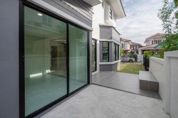 Modern house exterior with glass doors and patio