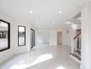 Bright and spacious main living area with modern staircase