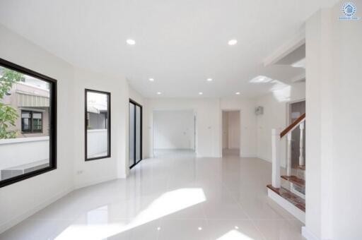 Bright and spacious main living area with modern staircase