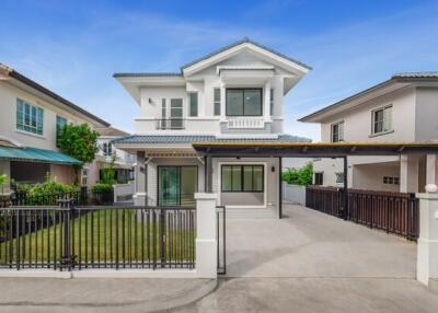 Two-story house exterior with driveway and front yard