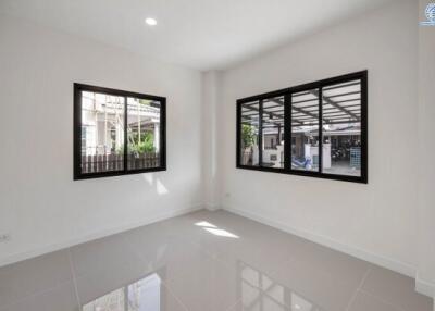 Empty room with large windows and tiled floor