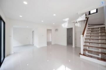 Bright and spacious living room with staircase