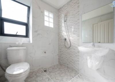 modern bathroom with toilet, shower, and sink