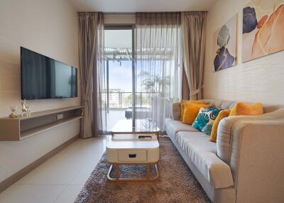 Modern living room with wall-mounted TV and balcony view