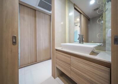 Modern bathroom with wooden cabinets and sliding doors