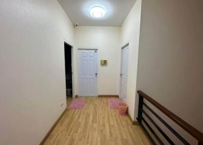 hallway with wooden flooring and doors