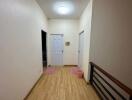 hallway with wooden flooring and doors