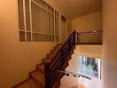 Indoor stairway with railing and large window