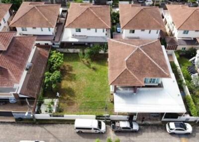 Aerial view of a neighborhood with multiple houses and a green lawn