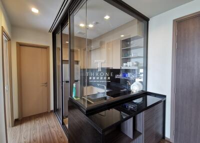 Modern kitchen with glass enclosure and wooden accents