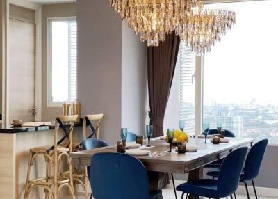 Luxurious dining area with large chandelier and modern decor