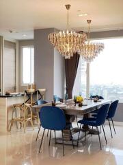 Luxurious dining area with large chandelier and modern decor
