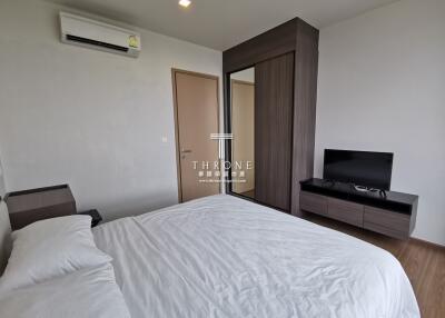 Modern bedroom with bed, air conditioner, wardrobe, and TV