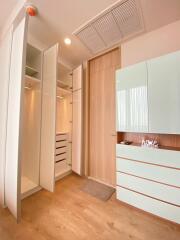 Modern bedroom with open wardrobes and sleek storage cabinets