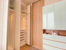 Modern bedroom with open wardrobes and sleek storage cabinets