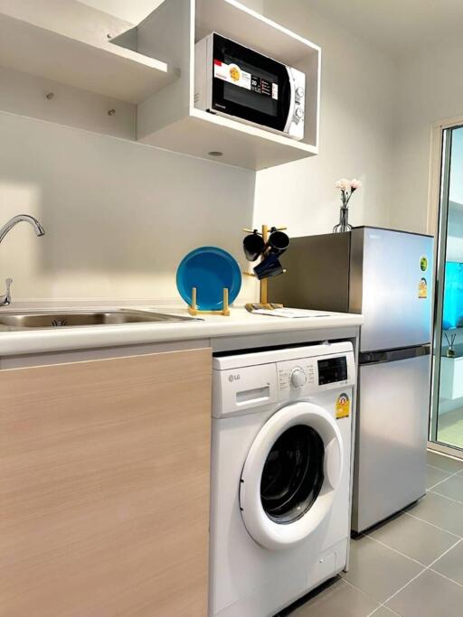 Modern kitchen with washing machine and refrigerator