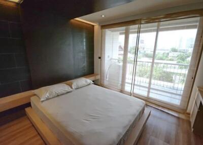Modern bedroom with a large window and balcony view