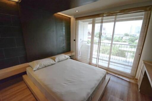 Modern bedroom with a large window and balcony view