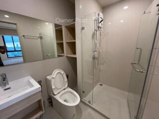 Modern bathroom with a shower, toilet, and sink