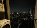 Balcony with night city view and washing machine