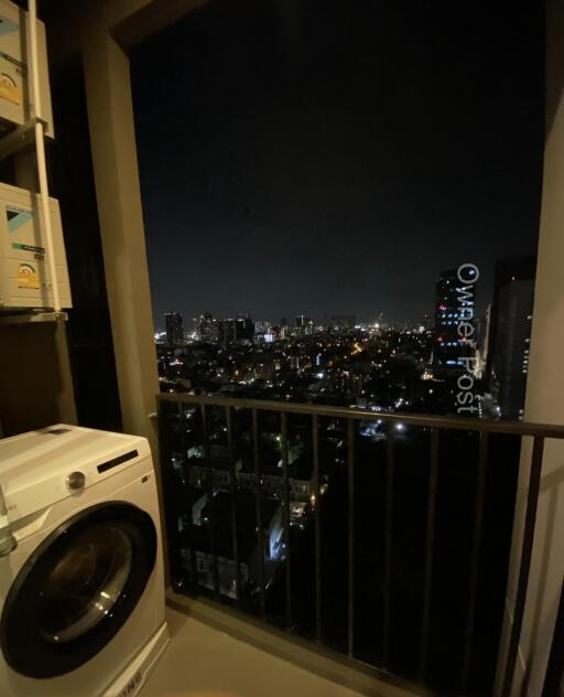 Balcony with night city view and washing machine