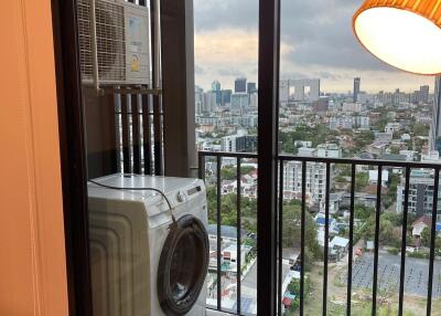 Balcony with view of cityscape featuring a washing machine