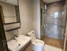 Modern bathroom with a shower, sink, and toilet