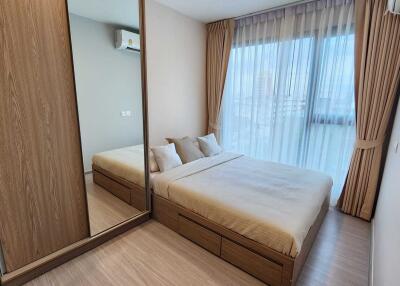 Modern bedroom with wooden furniture and large window