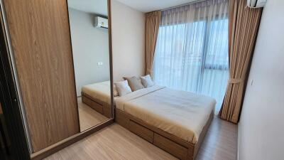 Modern bedroom with wooden furniture and large window