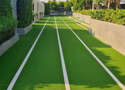 Well-maintained outdoor running track with lush greenery