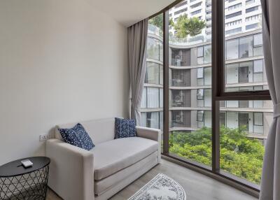 Small living area with a large window and modern furniture