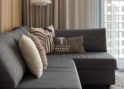 Comfortable living room with gray sectional sofa and decorative pillows