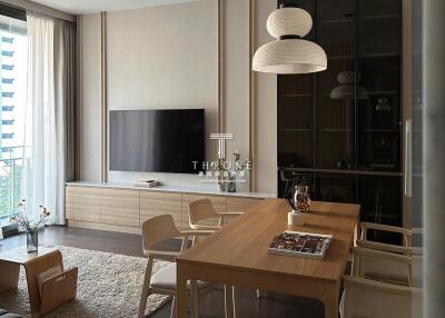 Modern living room with wooden dining table and wall-mounted TV