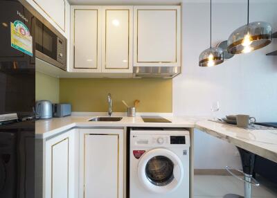 Modern kitchen with built-in appliances and washing machine