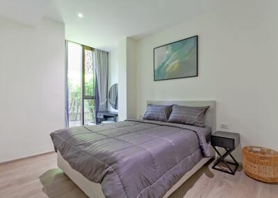 Bright and modern bedroom with double bed and large windows