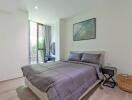 Bright and modern bedroom with double bed and large windows