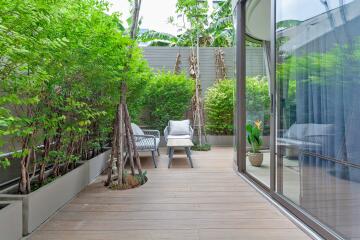 Outdoor terrace with seating area and greenery