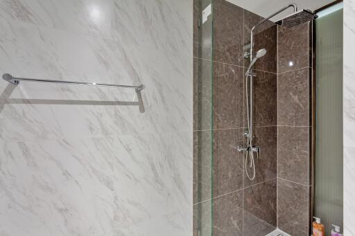 Modern bathroom with marble walls and a shower area