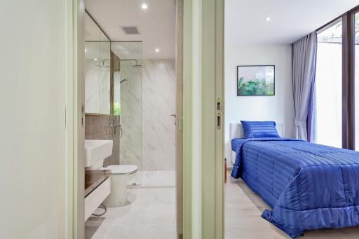 Bedroom and bathroom with glass shower door
