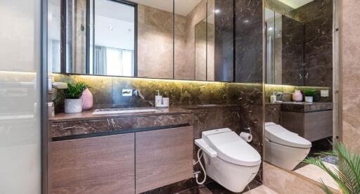 Modern bathroom with marble walls and built-in lighting