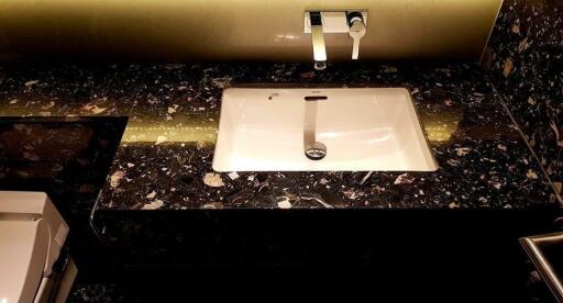 modern bathroom with black marble countertop and sink