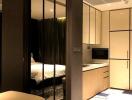 Modern bedroom and kitchen with built-in appliances and glass partition