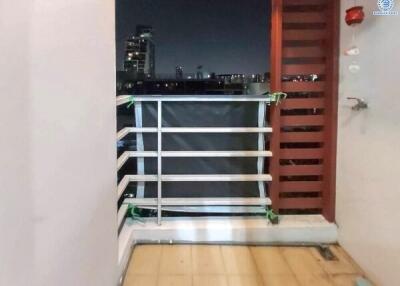 Small balcony with a night view of the city